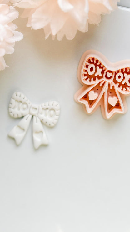 XOXO Bow Clay Cutter: Heart Ribbon Design with Script Embossing